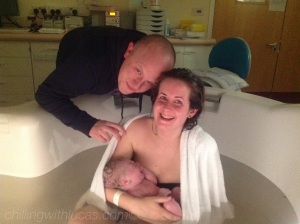 D and I when we first had Lucas. I am sat in birthing pool holding Lucas